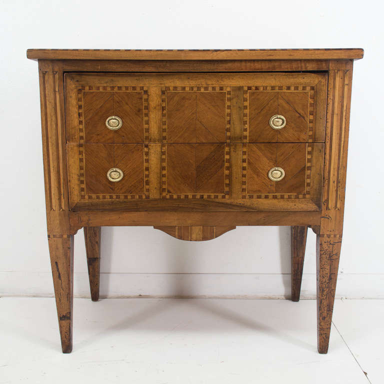 A Louis XVI commode made of solid walnut and veneer of cherry (1/4