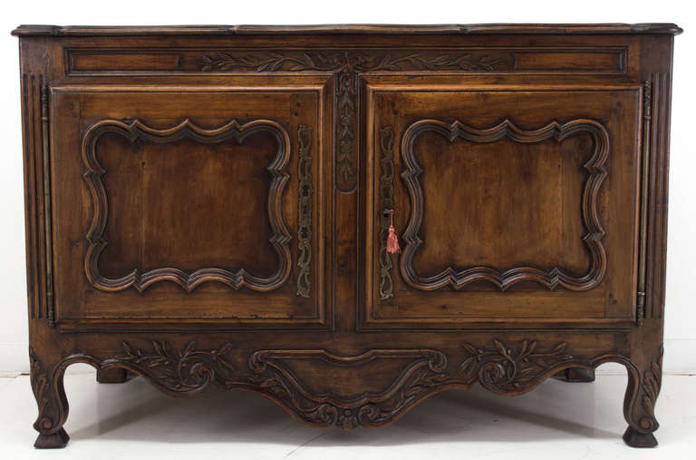 Made of solid walnut with two doors opening to one shelf inside and a carved apron, a good buffet from the turn of the 20th century. Waxed Patina.
As always more photos are available upon request and we have large selection of French Antiques.