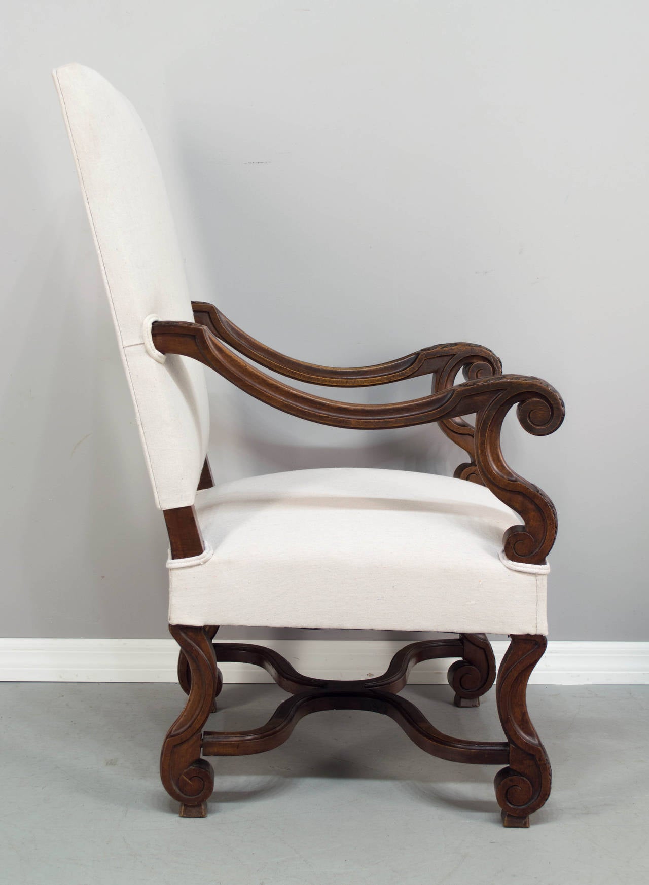 A good pair of Louis XIV style fauteuils, or arm chairs, c.1900-1920. Made of walnut with nice, hand carved details, sturdy construction and comfortable seating. The height of the arm rest at the front is 26.5