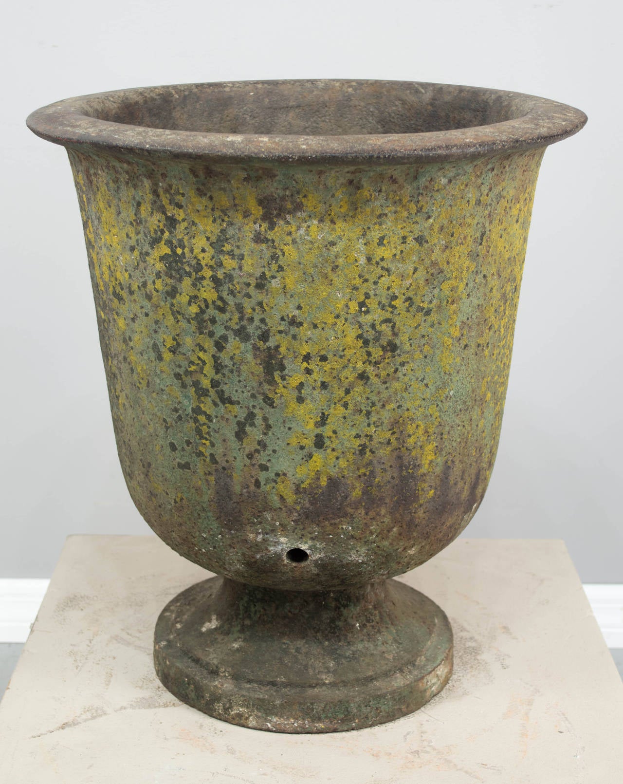 19th century French Charles X heavy cast iron urn, circa 1800-1810. Beautiful old moss colored patina gives this urn the look of glazed pottery. Perfect size for use as a small topiary planter. Weighs approximately 120 pounds. As always, more photos