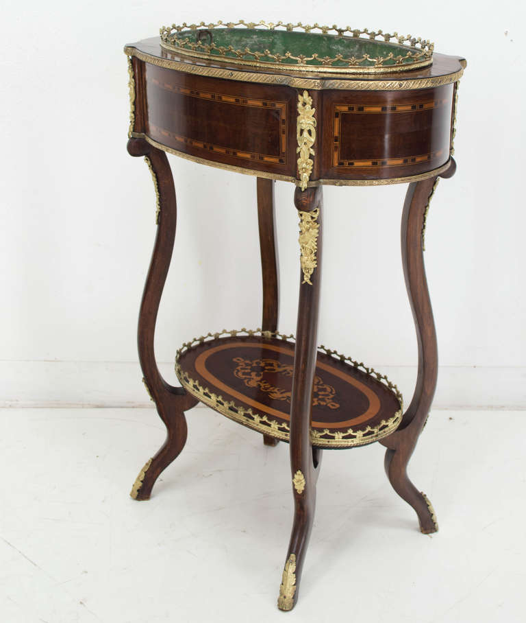 A late 19th c. Jardiniere, mahogany and walnut and ebonized veneer with bronze decoration, retaining its original tin insert, with a French polish finish.
As always, more photos available upon request. We have a large selection of French antiques.