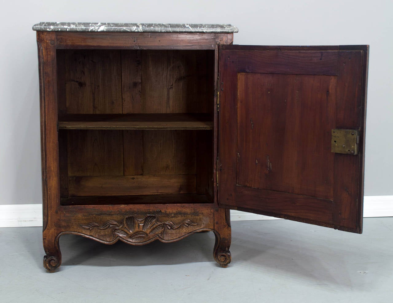 A 19th c. French Louis XV Style Confiturier or single door cabinet with a replaced marble top, solid cherry wood with brass hinges and steel escutcheon, a key and a working lock. A nice size cabinet having a marble top added at a later date. The top