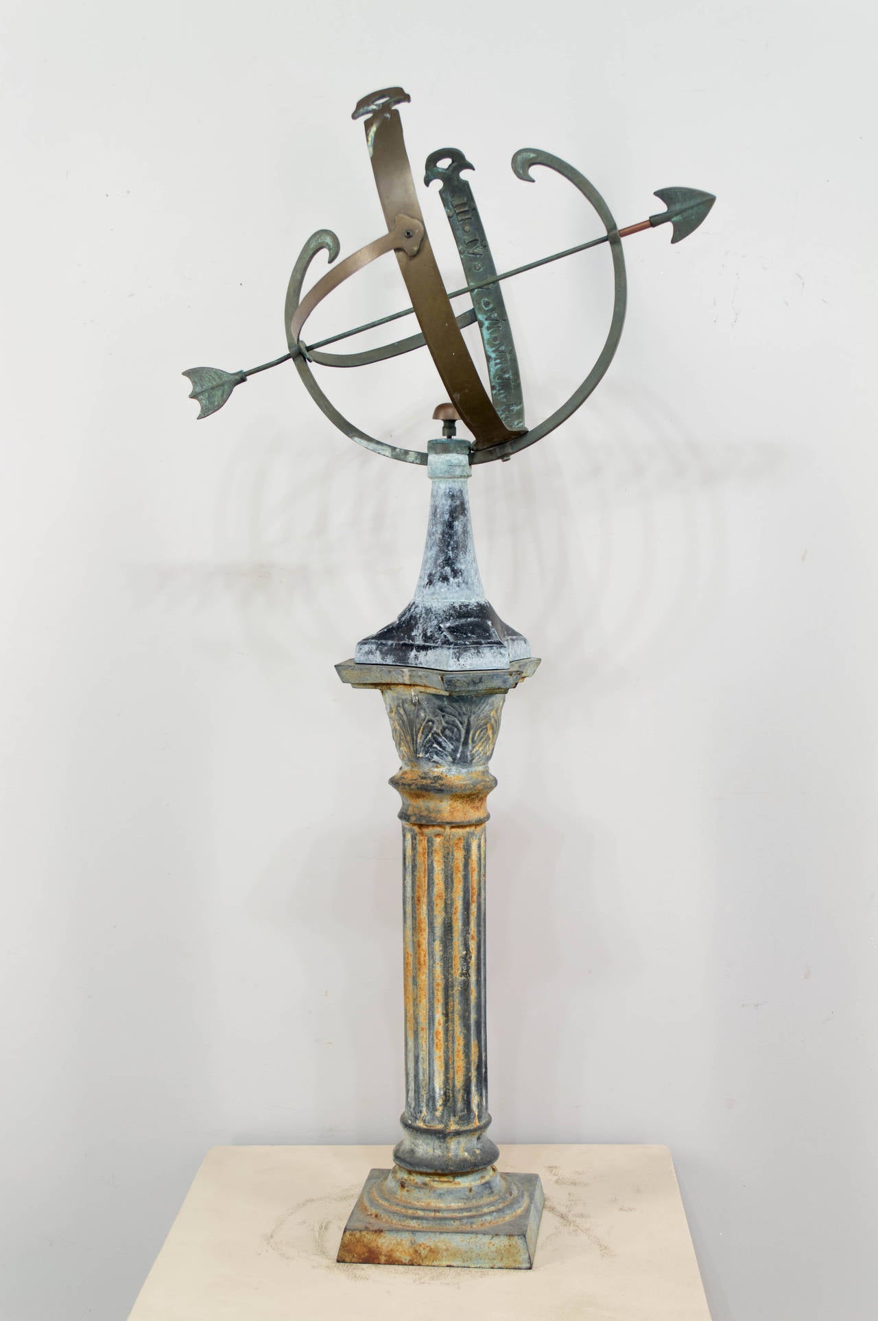 American armillary or sun dial made of copper with a cast iron base. Nice old weathered patina with some rusting on column form pedestal. Copper has a verdigris patina. As always, more photos available upon request. We have a large selection of