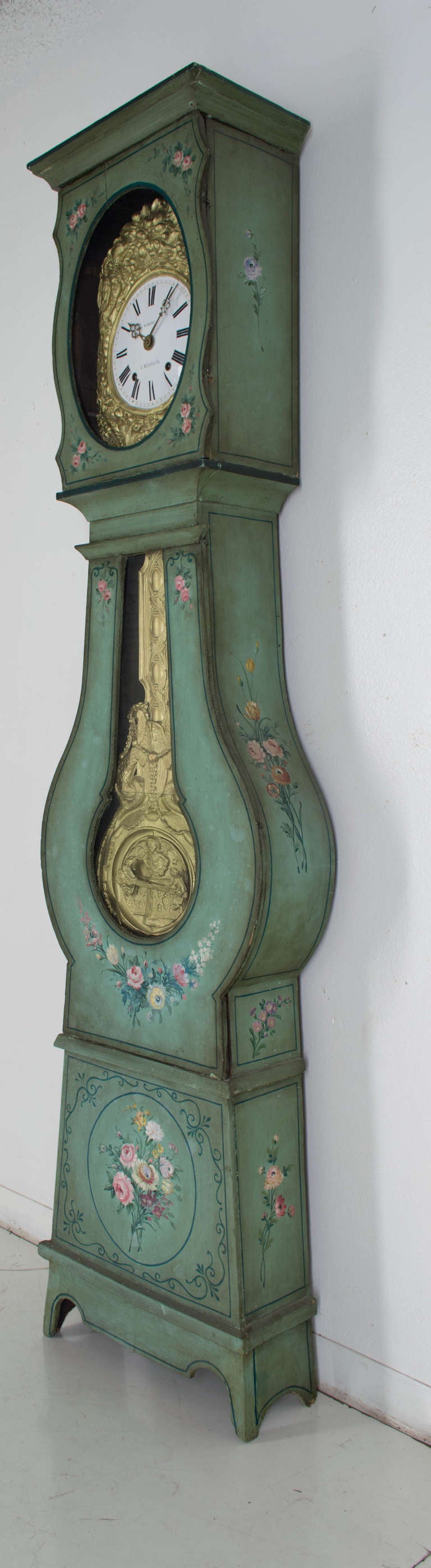 An original painted tall case clock on a light green background with bouquets of flowers painted on three sides, with its original Morbier movement, signed Vibert a Albertville (Alps province), seven day clock in working condition, with an automated