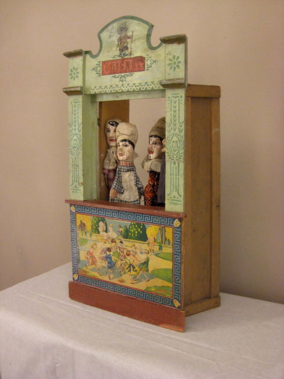 A Guignol theater with stand and four wood hand carved puppets.  All original. Two wood hands missing.<br />
More antiques at www.ofleury.com