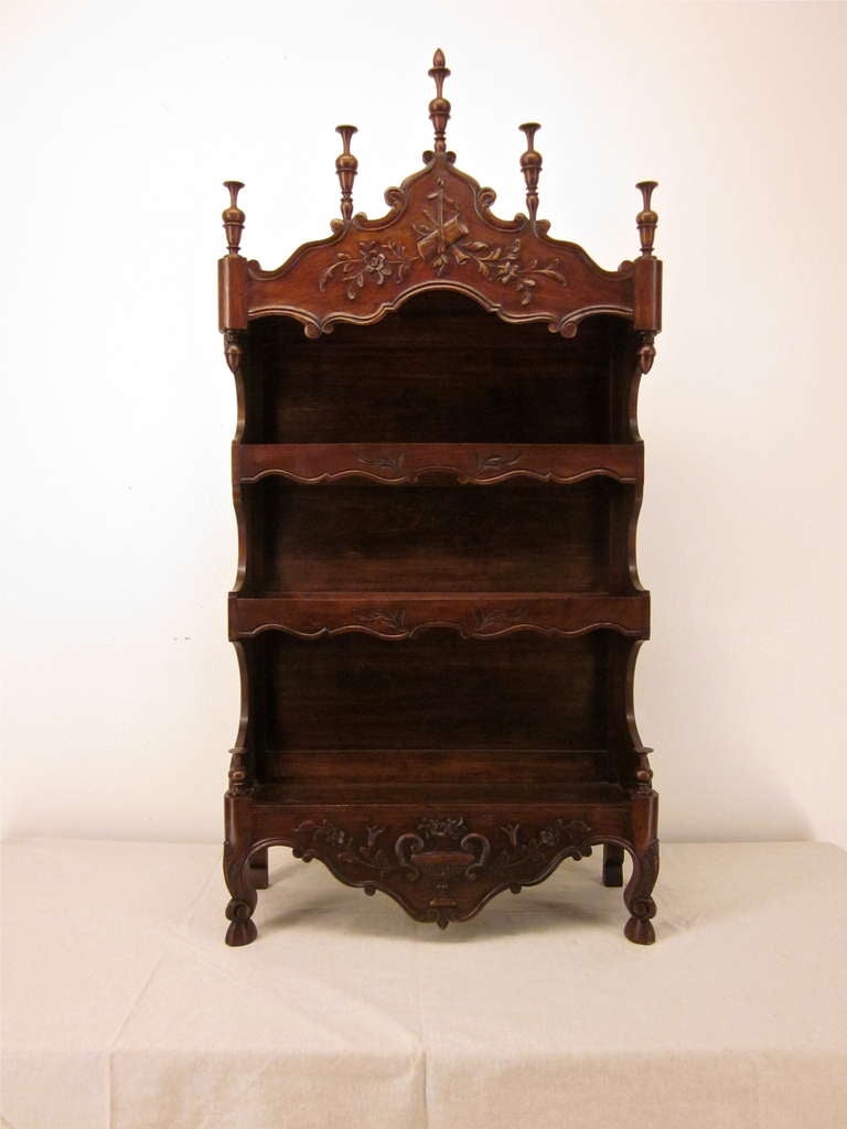 A very decorative shelf made of walnut from Provence with elaborate carvings and finals. 
