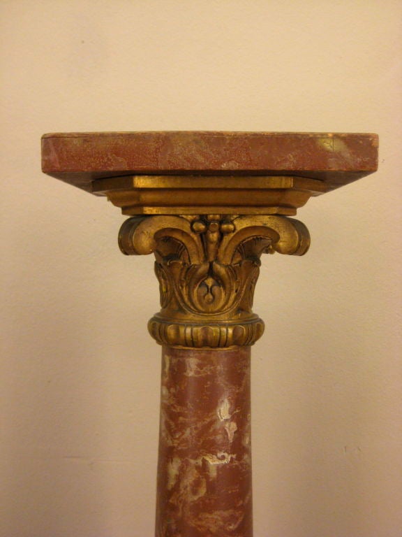 A pedestal made of wood with a faux-marble paint and gilt.
11