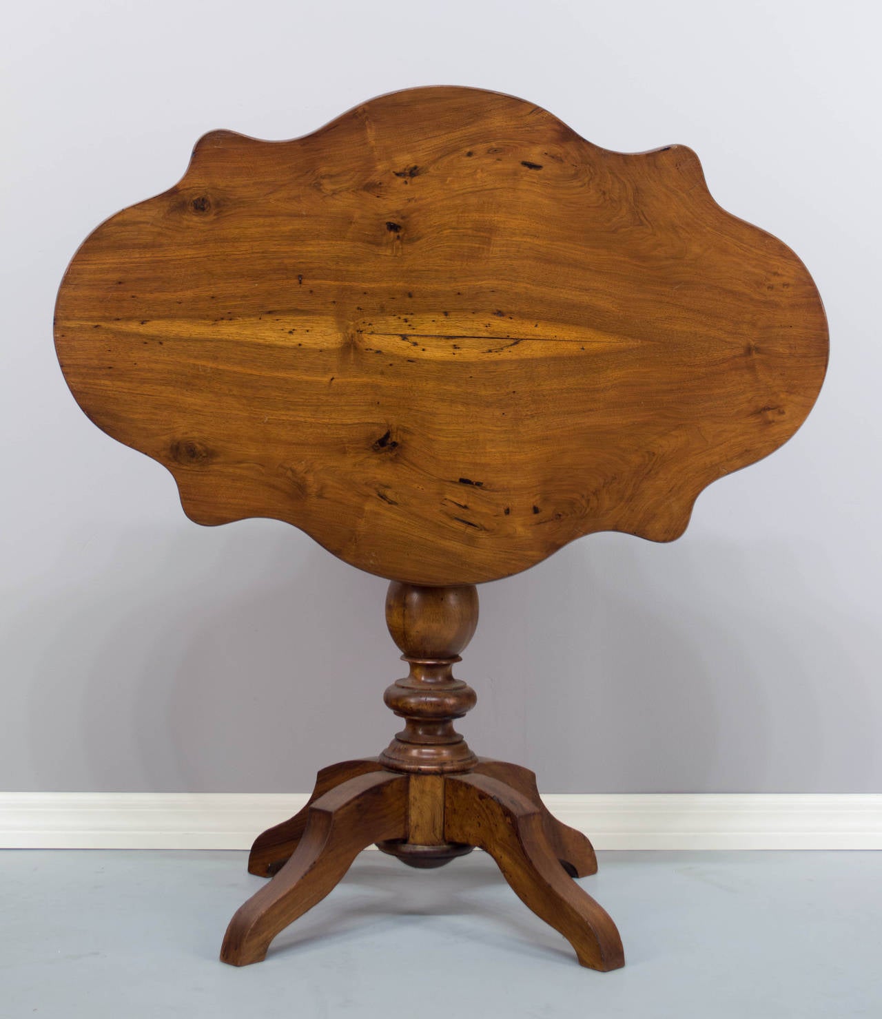 A 19th century Louis Philippe style walnut gueridon with bookmatched board. 43.5 inches tall when top is tilted up. Waxed finish.
More photos available upon request. We have a large selection of French antiques. Please visit our showroom in Winter