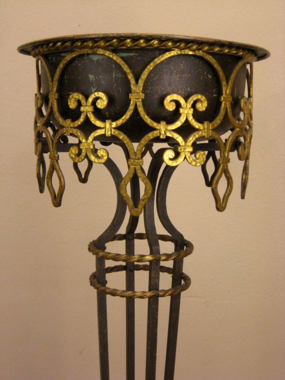Wrought iron plant stand with a copper insert. All riveted construction with great gilt iron detail.