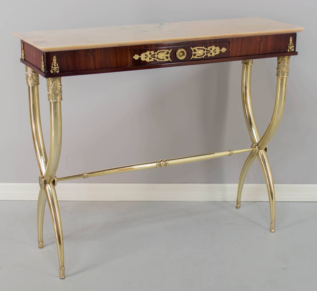 Italian console table with polished brass base and onyx top. Mahogany veneer with dovetailed drawer and decorative brass hardware. Slim profile with nice proportions and of very fine quality. All original. As always, more photos available upon