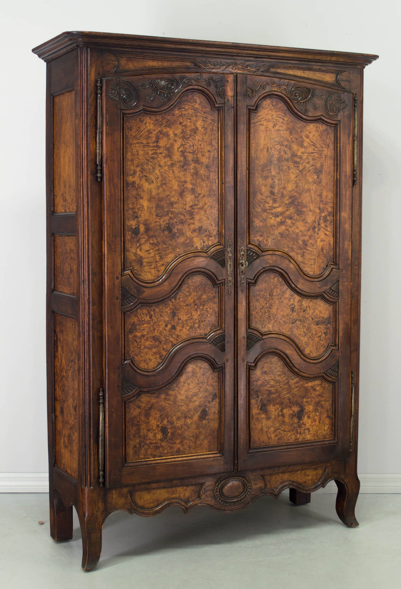 18th century French burl wood armoire from Burgundy made of solid walnut with nice hand-carved details. The doors and side panels are made of beautiful burl of elmwood. This armoire is small in scale (almost 70" high) and was used as a