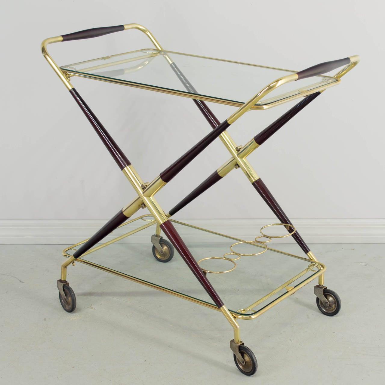Mid-Century Italian bar cart by Cesare Lacca. A very nice high quality drinks trolley made of brass and rosewood with removable glass trays. This cart is hinged and can be folded for easy storage. Superb design and well-made. Original wheels glide