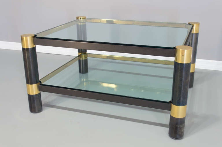 Heavy Karl Springer rectangular coffee table, gunmetal with polished brass details. Superior quality craftsmanship with nice patina. Thick beveled glass top and lower shelf.