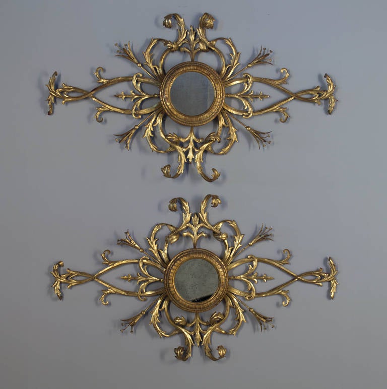 A good pair of 1960s gilded tole wall decoration with a center mirror from Italy.