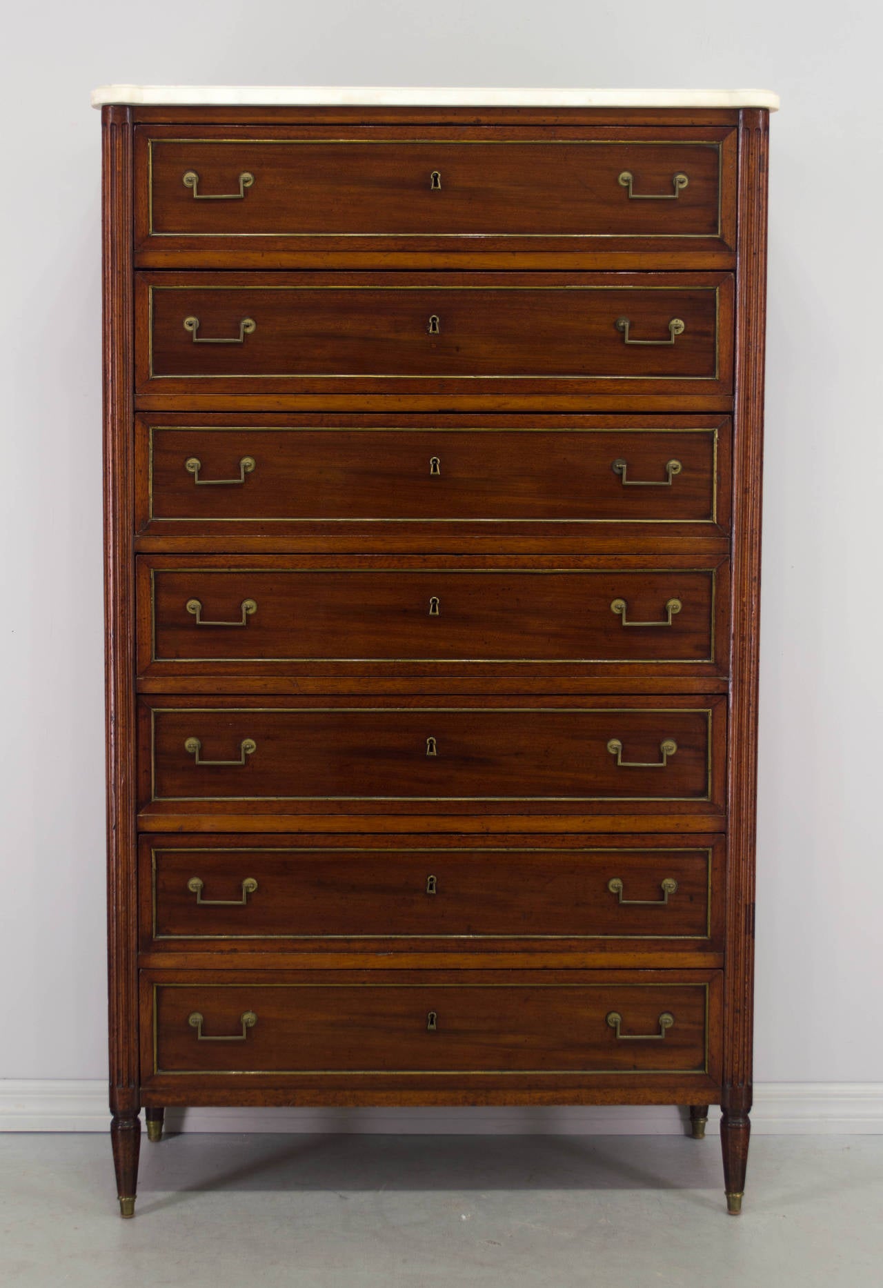 19th century Louis XVI style semainier or gentleman's chest with seven long dovetailed drawers originally meant to hold a week's supply of clothing. Made of solid and veneer of mahogany with oak as a secondary wood. Nice proportions and subtle