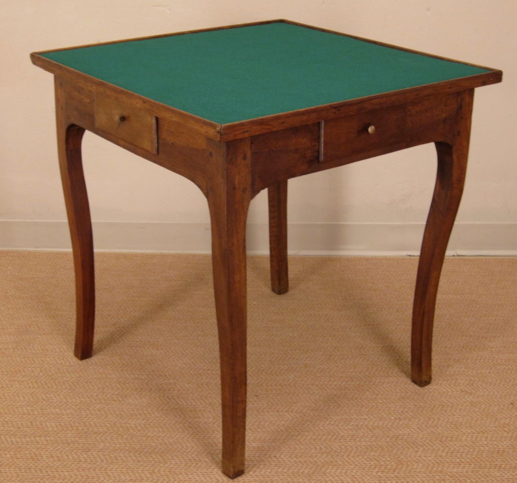 A game table made of walnut with four dovetailed drawers. Pegged construction. New Green felt.
For many more fine antiques, please visit our online gallery at: www.ofleury.com