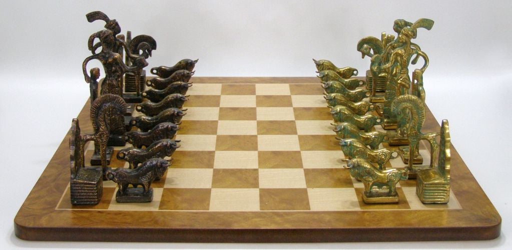 This unusual chess set is done in the style of Frederic Weinberg, circa 1960s. The vintage chess pieces have an Egyptian Revival design and are composed of solid brass, with one player's pieces having a bronze finish and the opponent's pieces having