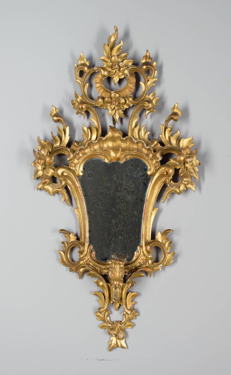 A pair of Italian mirrors with a candleholders, original gilt and mirror. Very elaborate carvings, could be wired. Note the mirror part is original and the reflections is not clear.
More photos available upon request. We have a large selection of