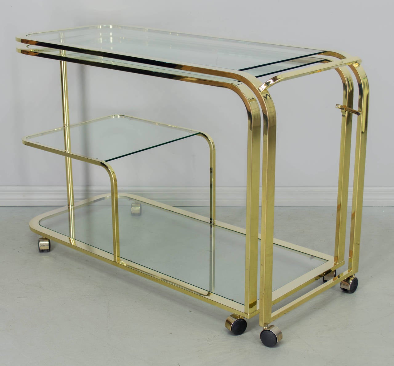 An exceptional design, this rolling bar cart swivels open into a sideboard for extra serving space or can be positioned at a right angle and used as a desk. A versatile piece, this easily converts the home office of a studio apartment into a place