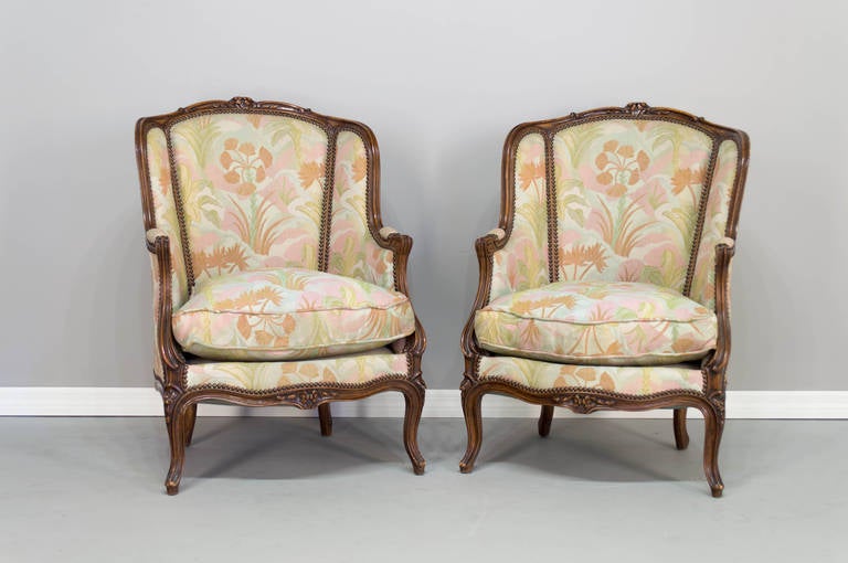 A Louis XV Style Salon Set, including a two seat sofa and a pair of bergeres, beechwood frames with a walnut stain, floral carvings and original fabric in good condition.
The arm chairs measures 29