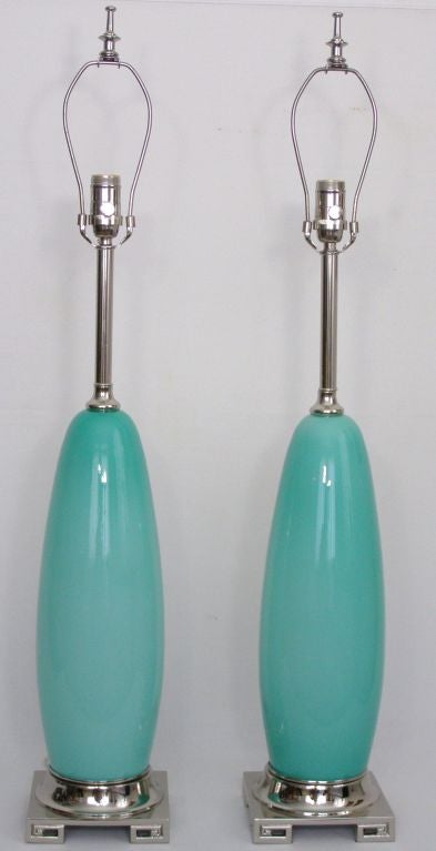Pair of tall aqua blue Murano glass lamps, circa 1960's. Height to top of glass is 19.5 inches. Newly nickel plated Greek key bases and hardware, including finials. Heavy duty nickel plated sockets with new wiring. Shades not included.
For many