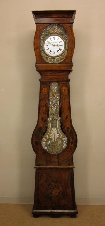 A Comtoise with its original Morbier works, chiming on the hour and two minutes after and on the half, with its pine case polychrome paint and original glass.<br />
In working order and professionally cleaned.<br />
<br />
For many more fine