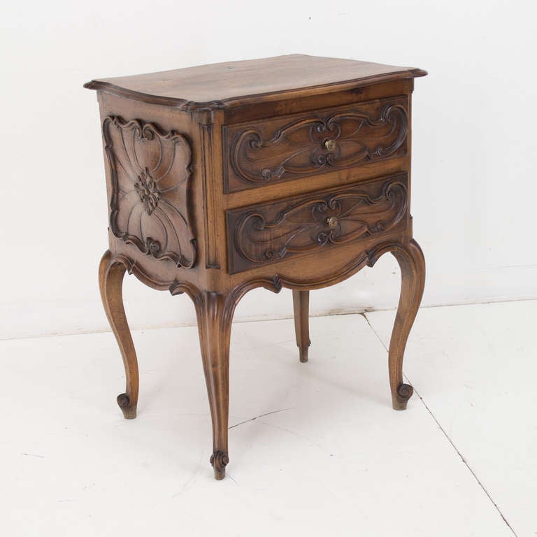 A late 19th century walnut side table with two carved dovetailed drawers and decoration on the sides on four cured legs ended by a scroll toe.
Finished on all sides.
As always, more photos available upon request. We have a large selection of