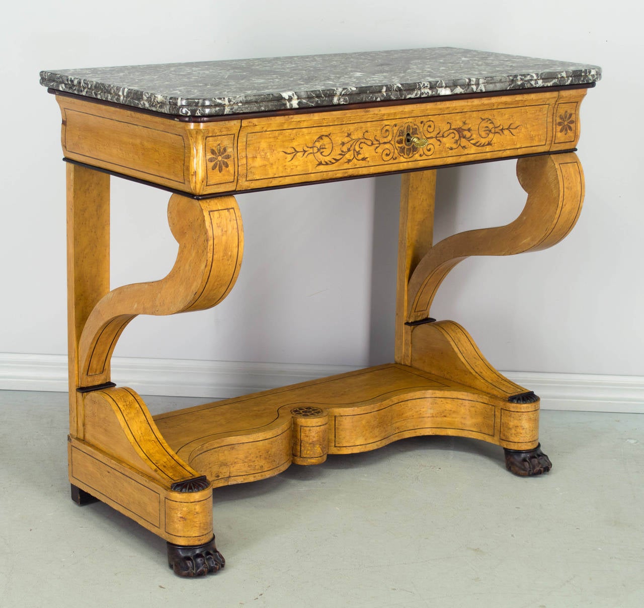 19th c. Charles X style console, c.1860-1880, made of birds eye maple veneer, with a dovetailed drawer and a thick grey veined marble top. Nice inlay and French polish finish. Working lock and key. Good original condition with some veneer missing on
