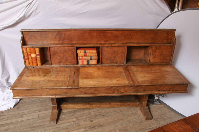 Only three ever made. 

A 1930`s Robert ``Mouseman`` Thompson Oak Double School Desk, the central upright with open and closed book compartments, above two sets of three sloping desks, on two shaped supports joined by a floor stretcher, with
