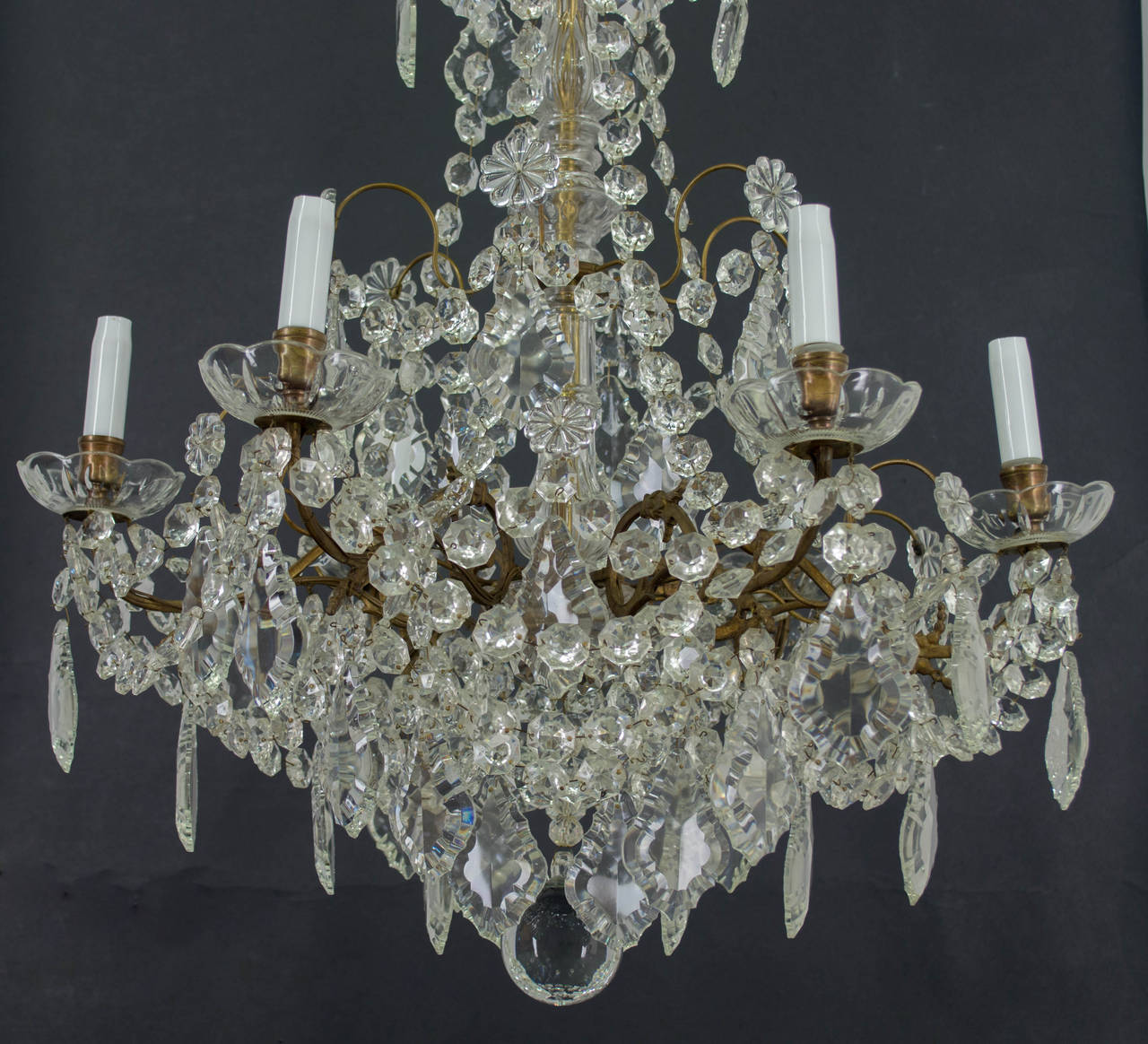 French six light chandelier with molded crystal boboche and an assortment of crystal prisms and chains. Brass frame. original white glass candle covers. Wired using European sockets. More photos available upon request.Please visit our web site for a
