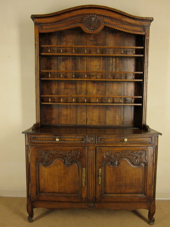 A French Louis XV Style Vaisellier or Hutch from the Normandy Province having two carved door below two drawers. Brass Hardware.
For many more fine antiques, please visit our online gallery at: www.ofleury.com