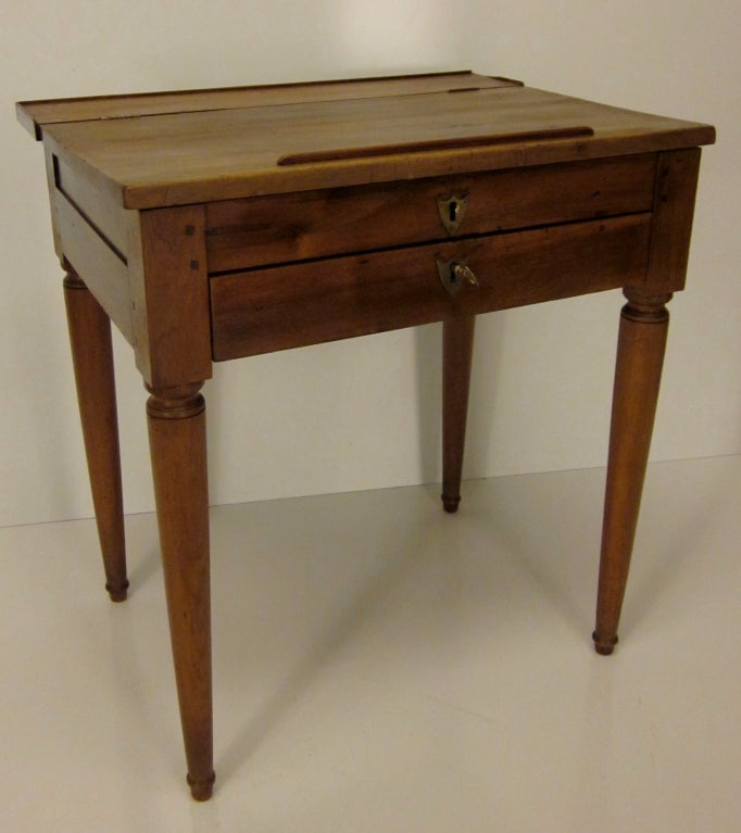 An original Empire style school desk made of walnut with one dovetailed drawer and pegged construction.