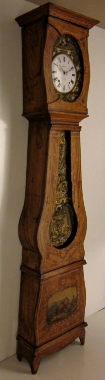 A very attractive seven day Morbier clock in a painted pine case from the east of France. Chimes on the hour and two minutes after and on the half.  The sound is a gong. The brass is embossed and represents some peacocks and the bottom painting show