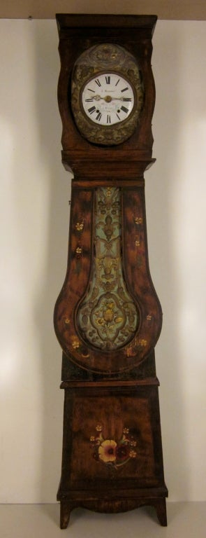 A seven day morbier movement in a pine case, polychrome paint from the East Of France. Chimes one the hour and two minutes after and once on the half. Face and pendulum are brass embossed with original paint.