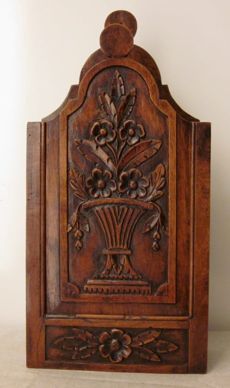 This beautiful example of a French Fariniere is constructed with dovetailed joinery in walnut. From Provence, a fariniere is a sliding paneled box used for dredging fish in flour. Hand carved and beautiful patina.