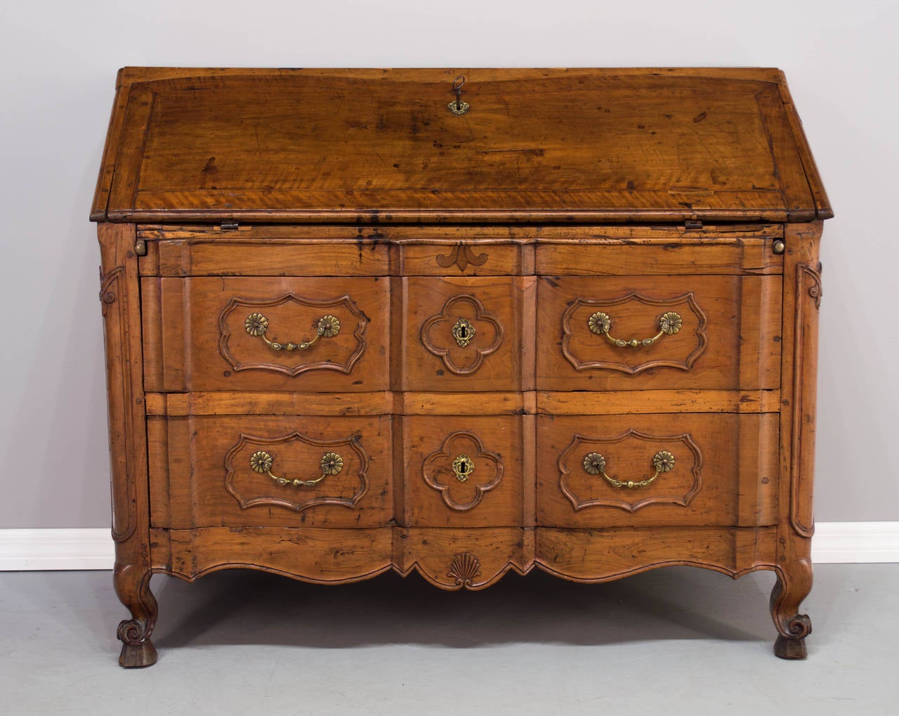 A fine Period 18th c. Louis XV scriban or slant desk from the Southwest of France, c.1740-1760. Made of solid walnut with serpentine front and two dovetailed drawers. Desk opens to reveal small drawers with two secret compartments. Curved legs
