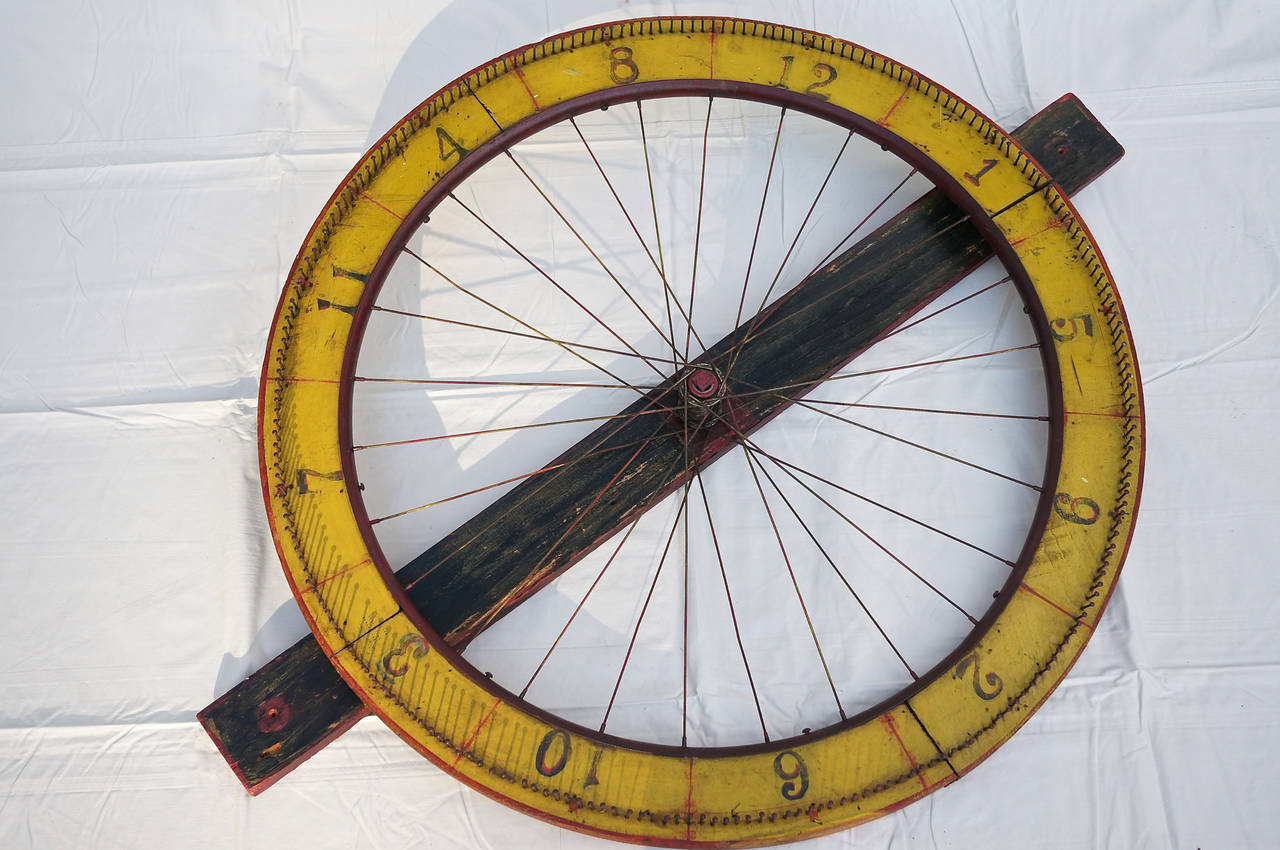 A whimsical and fun gaming wheel. This wired spoked wheel is painted in bright yellow ochre and red. It spins on a hub not unlike a bicycle.
More photos available upon request. We have a large selection of French antiques. Please visit our showroom