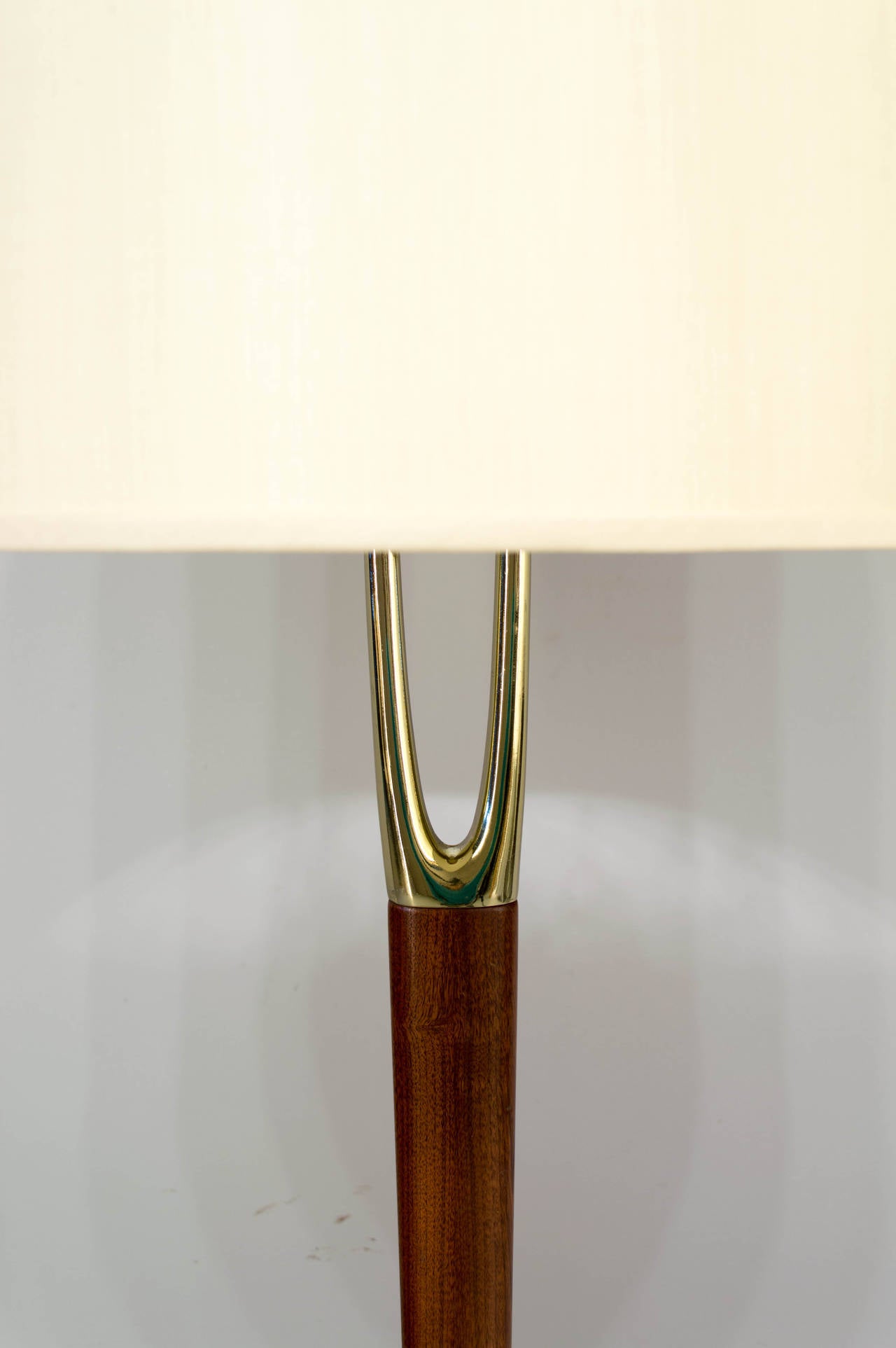Iconic, sought after Mid Century Modern floor lamp made by the Laurel Lamp Company. Solid teak wood center post with beautiful wood grain. Brass plated wishbone shaped prong at top and a brass plated base. Rewired.
48