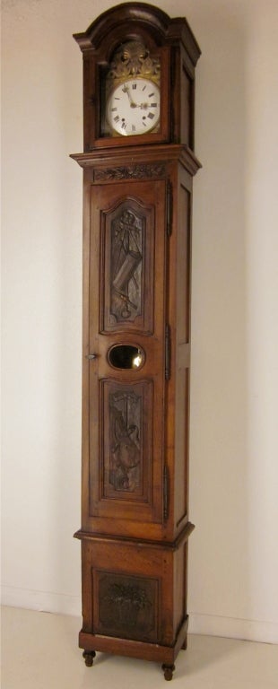 A walnut tall case clock from the Provence region, with fine carvings and a chapeau de gendarme crown. The Morbier movement keeps a good time, chime on the hour, two minutes after and once on the half. In two parts.