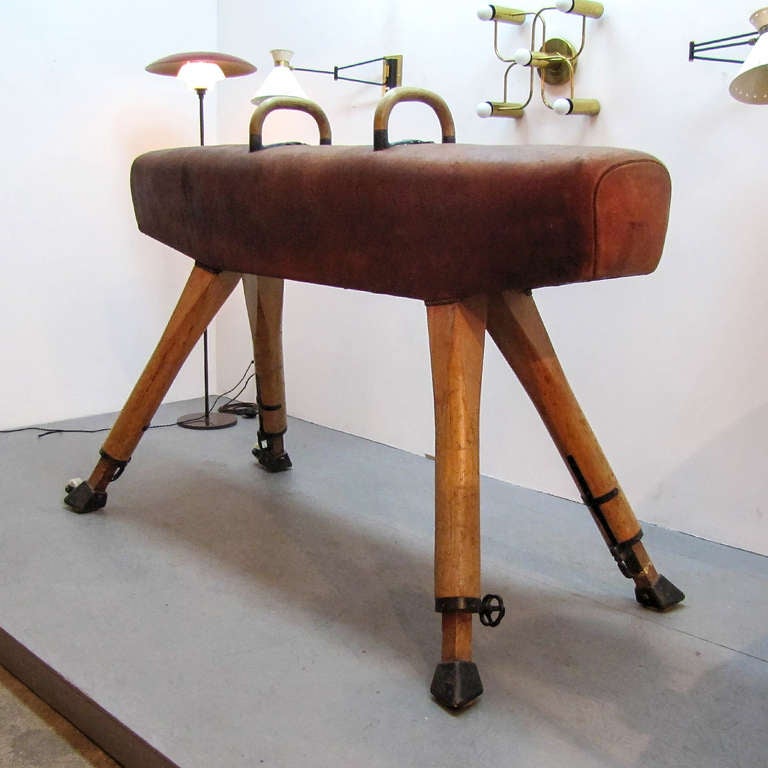 stunning german vintage leather covered pommel horse from the 1st half of the 20th c., with oak legs and beautifully patinaed leather top, metal hardware with two rolls, adjustable height in 2 inch steps from 43