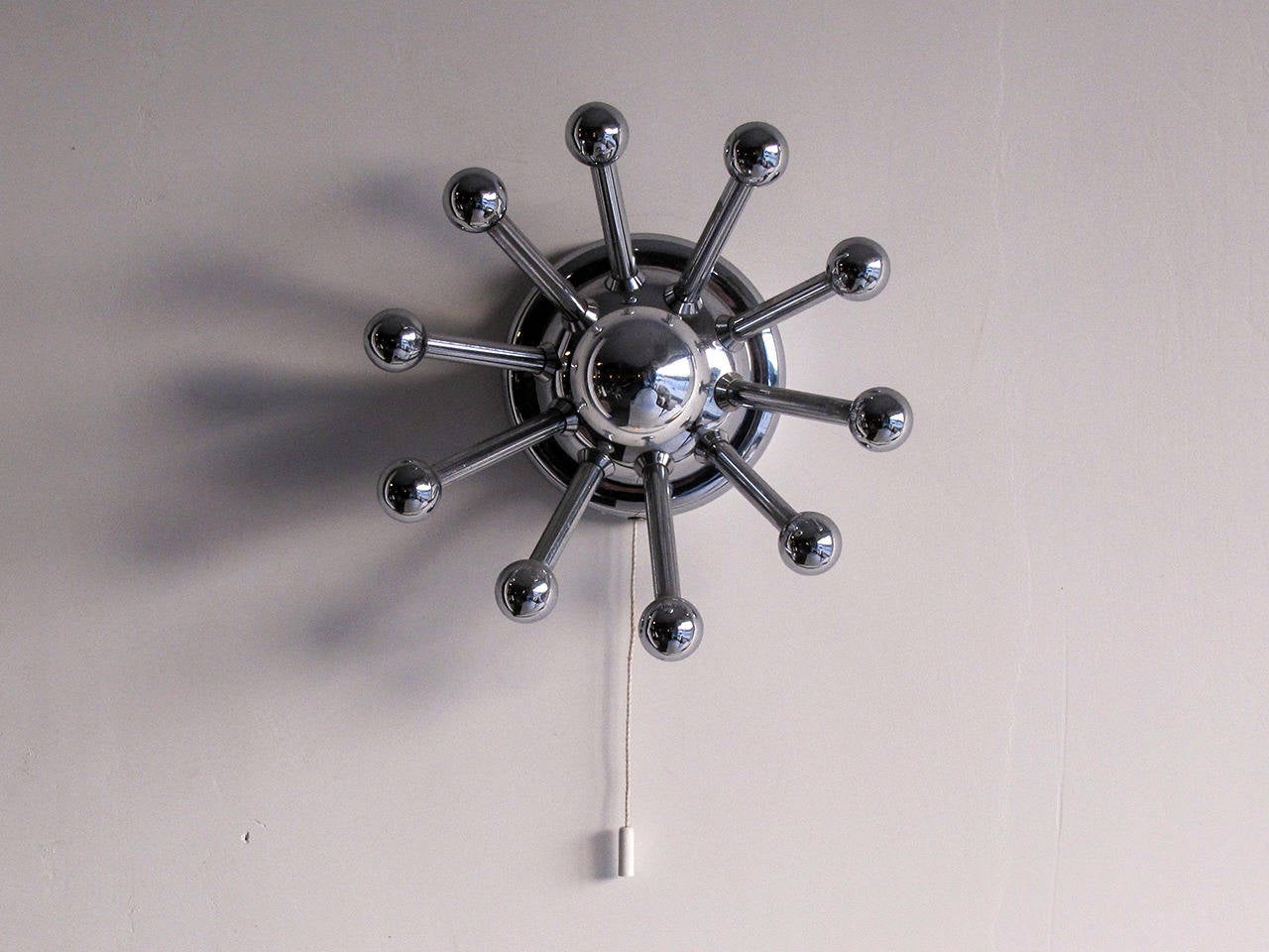 Petite chrome-plated ten-arm Sputnik sconces, single bulb with individual pull switch, can be used as ceiling lights.