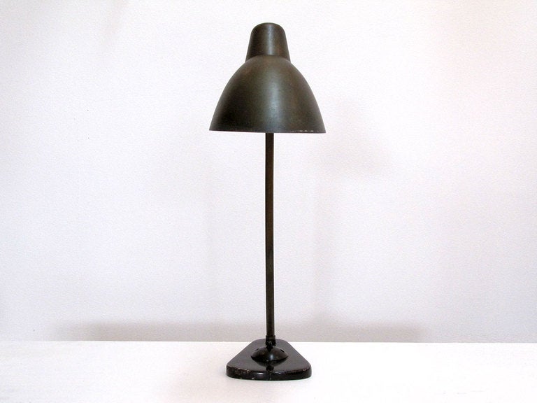large brass "conductor" table lamp by Louis Poulsen
patinaed brass, brown enameled base with bakelite on/off switch Produced as conductor lamps for the National Railway System