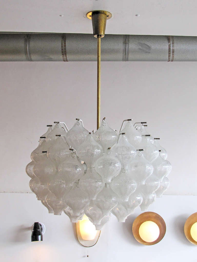 spectacular glass chandelier by J.T. Kalmar, 84 Tulipan glasses, tiered in six rows surrounding the 12 bulb light source, tulipan refers to the shape of the blown glass pieces