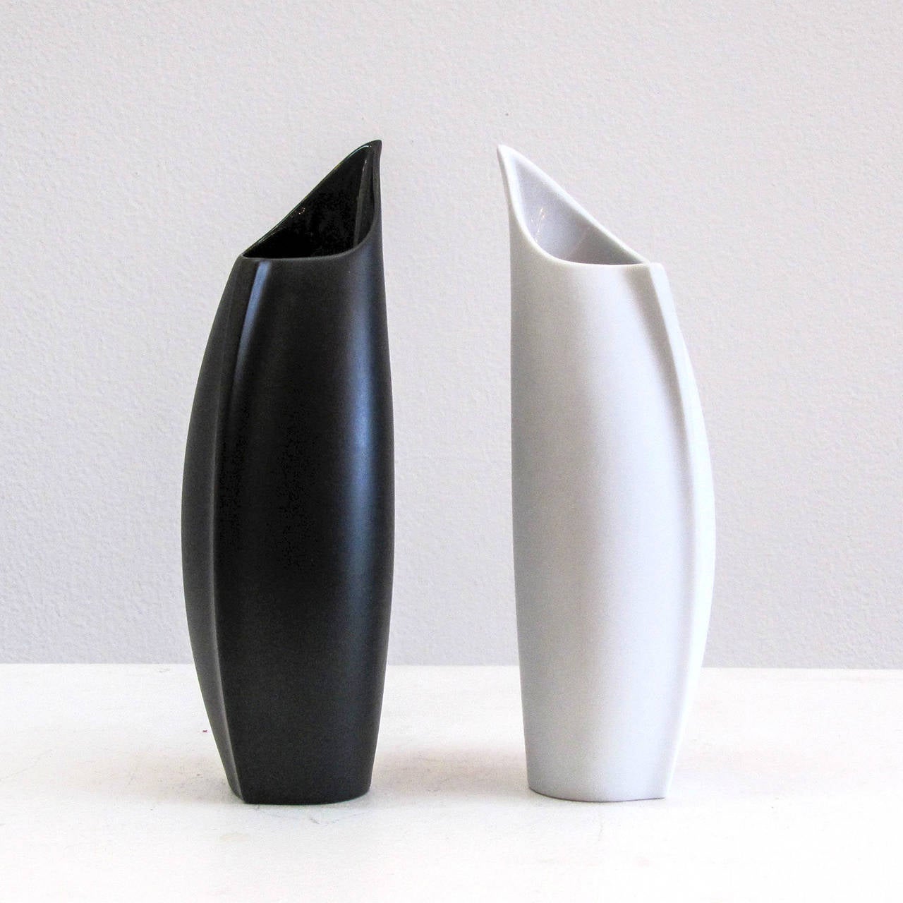Two delicate porcelain vases by Lino Sabattini for Rosenthal, Germany, one black, one white vase in matte exterior and gloss interior finish, signed. Priced individually.