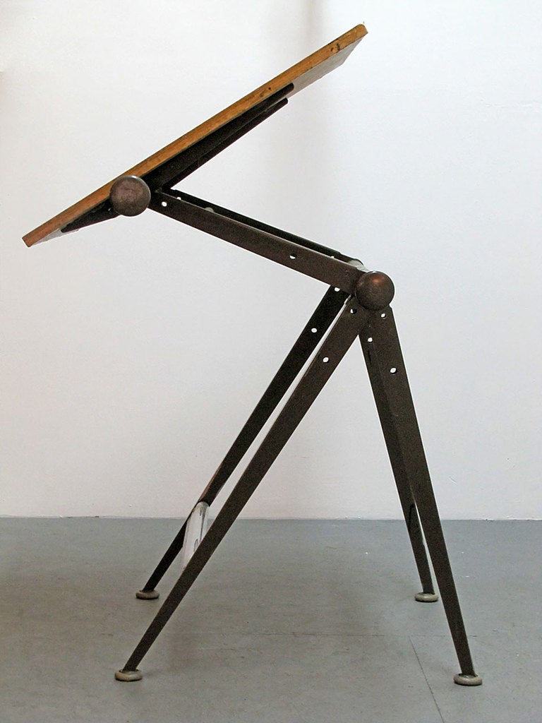 great drafting table with fully adjustable top, designed by Wim Rietveld with (technical advisory by) Friso Kramer manufactured and distributed by De Cirkel in 1968. great patina, original gun metal gray painted metal frame, birch plywood top