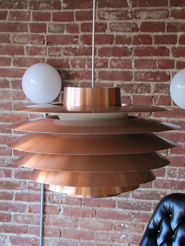 wonderful large tiered pendant by Sven Middleboe.
copper rings graduating from top to bottom, white enameled interior