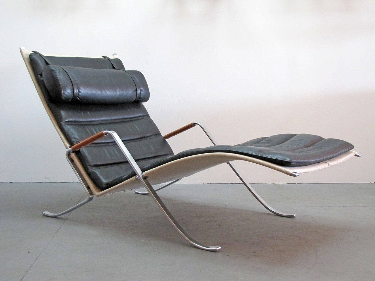 "Grasshopper" chaise longue designed by Preben Fabricius and Jørgen Kastholm, manufactured by Lange, chrome plated steel with canvas and loose neck support and cushions in black leather.