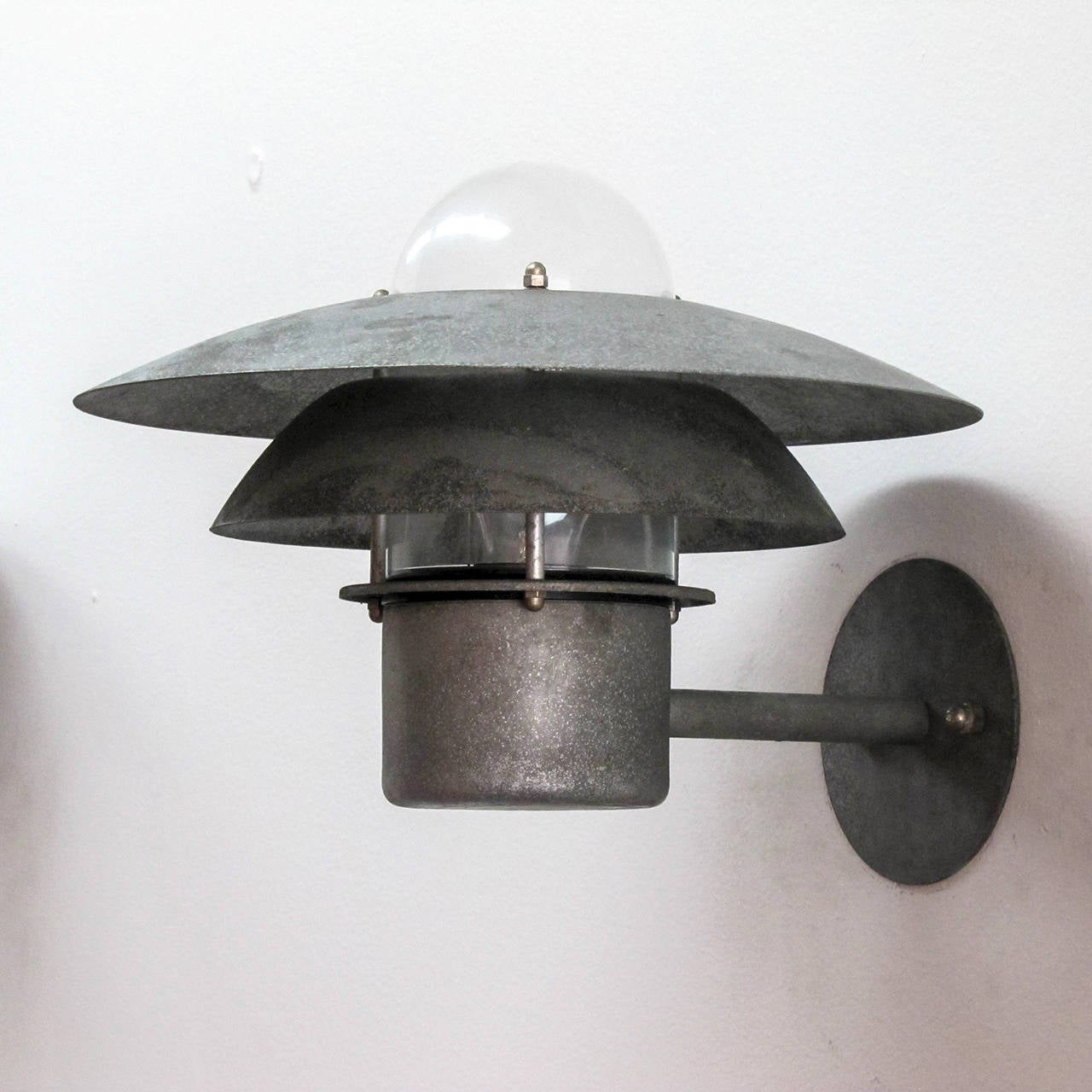 Wonderful Danish outdoor wall light by Danalight in galvanized steel with glass bulb enclosure.