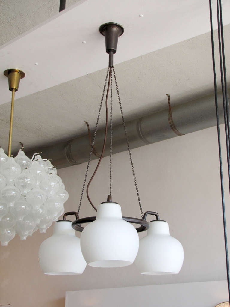 rare browned brass three-branch version of the Vilhelm Lauritzen B&G ring chandelier, with matte opal glass bowl shades, suspended from brass chains, with original canopy