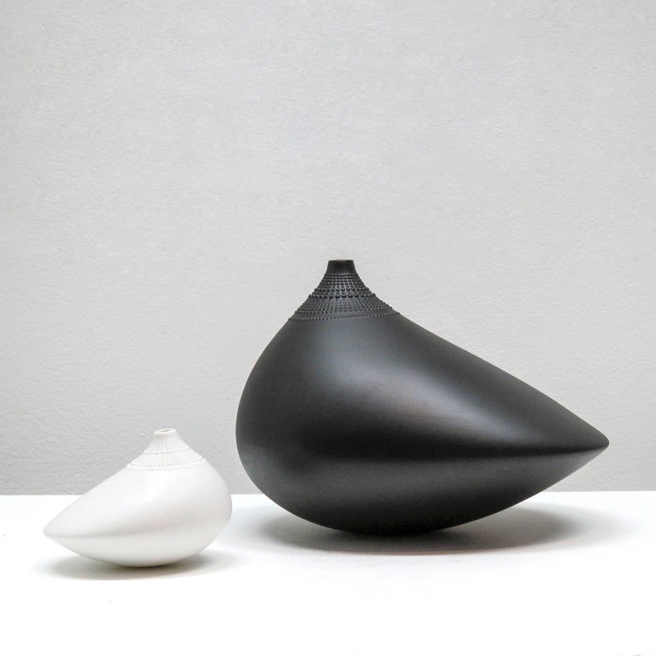 Beautiful matte black porcelain vase by Tapio Wirkkala for Rosenthal Studio-Line, comprised of a narrow neck with beaded collar and an elongated asymmetrically bulbous body, marked.